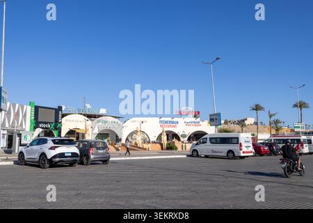 Sharm El Sheikh Egypt, 1st May 2026: Restaurants and shops in Old Market Sharm El Sheikh Egypt with vehicles businesses palm trees and desert surround Stock Photo