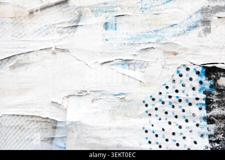 Old grunge torn collage urban street posters. Ripped faded paper placards on billboard Stock Photo