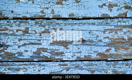 Close-up of old wooden planks with peeling light blue paint Stock Photo