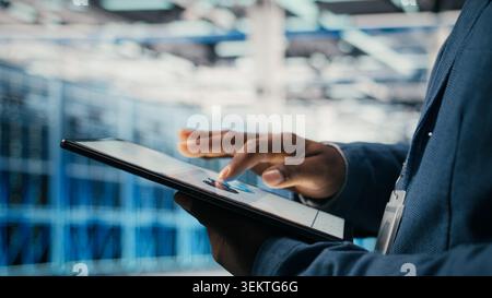 Using AI software, tablet close up and engineer in data center optimizing performance and forecasting issues. Automating operations, artificial intelligence and programmer in data center , camera A Stock Photo