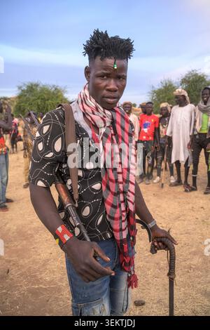 Nuba man posing with a Kalashnikov on his shoulder during a gathering in the Nuba mountains. Stock Photo