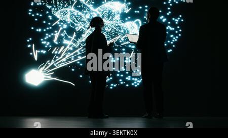 Adjusting AI parameters, machine learning model and engineering team doing optimizations. Modifying datasets, neural network architecture projection and colleagues in tech startup brainstorm, camera B Stock Photo