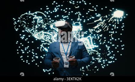 Software developer monitoring AI cognitive systems using VR headset gear. African american man using virtual reality simulation to study neural network nodes activity, camera A Stock Photo
