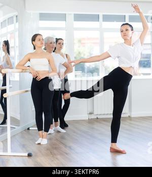 Adult woman teacher showing ballet movements Stock Photo