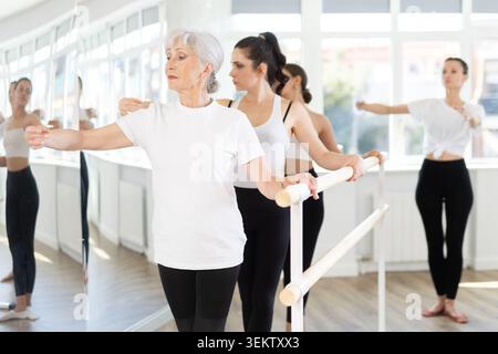 Adult woman teacher showing ballet movements Stock Photo