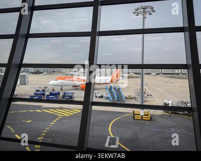 PARIS, FRANCE - MARCH 6, 2026: easyJet aircraft on the apron of Paris Charles de gaulle airport, with ground service vehicles, airport equipment. Easy Stock Photo