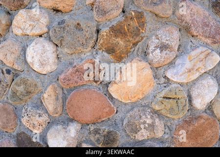 River Rock Wall Texture for Exterior Design, Natural Stone Cladding Background and Durable Fac Stock Photo
