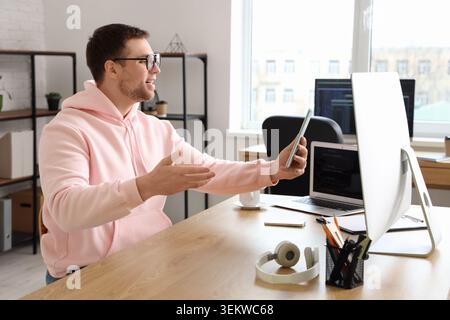 Portrait confused of male programmer working with tablet computer in office Stock Photo