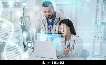 Medical researchers analyzing patient data with digital healthcare interface in modern laboratory, doctors using computer and laptop for diagnostics, Stock Photo
