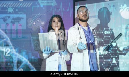 diverse doctors using laptop and tablet with futuristic medical interface, digital healthcare analytics, telemedicine monitoring, hospital innovation, Stock Photo