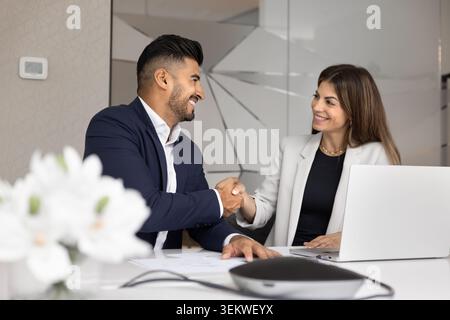Business partners shaking hands during meeting in corporate office Stock Photo