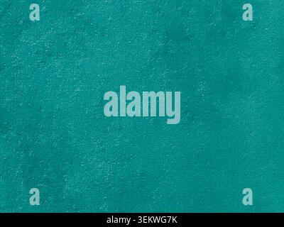 Full frame close-up of a vibrant teal green carpet surface with soft fiber texture. Simple and minimalist plain textile backdrop perfect for copy spac Stock Photo