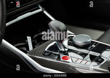 Lucerne, Switzerland, May 30, 2026. Close-up view highlights the automatic gear shift lever, red engine ignition button, and iDrive controller on the Stock Photo