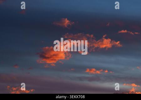 Vibrant fiery orange-red clouds at sunset. Stock Photo