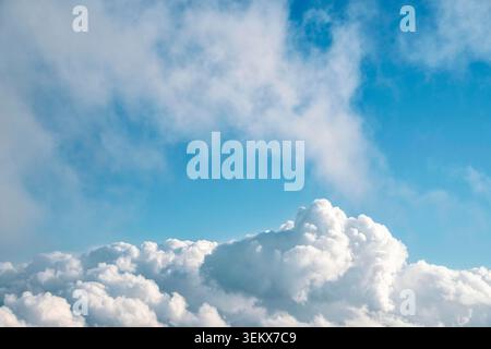 A serene blue sky with fluffy white clouds Stock Photo