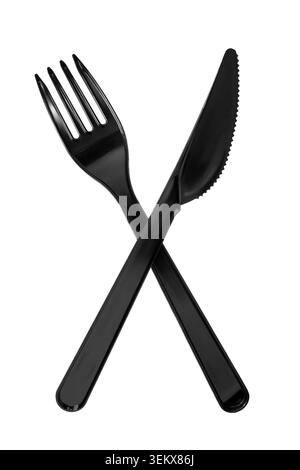 Crossed black plastic fork and table knife isolated on white background Stock Photo