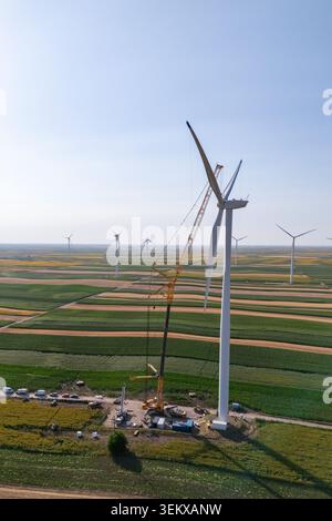 Aerial view of wind turbine construction featuring a tall tower ...