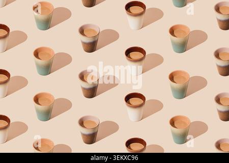 Trendy coffee pattern on light cream background. Minimal creative coffee concept. Coffee cups aesthetic. Stock Photo
