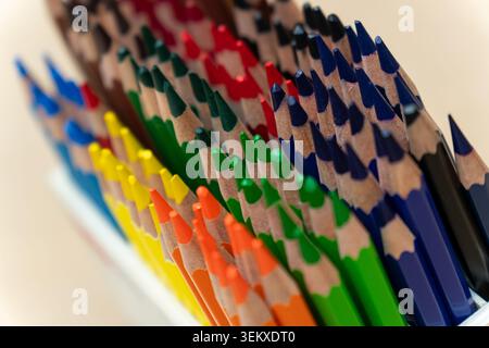 Macro shot of sharpened colorful wooden pencils arranged in a color gradient Stock Photo