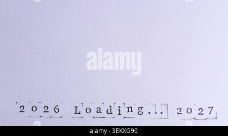 Words 2026 Loading... 2027 are stamped at bottom clean white textured paper sheet Stock Photo