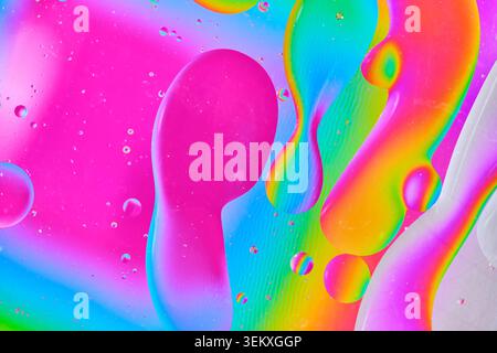 Abstract bright fluid art with colorful oil drops on water surface. Rainbow macro background Stock Photo