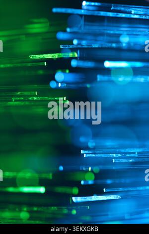 Glowing blue and green fiber optic cables texture background. Bright abstract digital technology Stock Photo