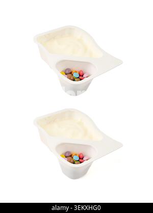 Yogurt cup isolated, yoghurt with colorful dragees in plastic pot, milk pudding container, glazed chocolate buttons, dairy food small package on white Stock Photo