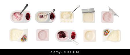 Assorted yogurt cups isolated, many different yoghurt with fruits pieces in plastic pots, spoon in milk pudding container, dairy food small packages o Stock Photo