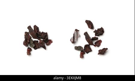 Dried chopped black vegetable isolated on white background top view. Dry beetroot flakes, dehydrated beet root pieces collection Stock Photo