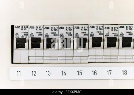Circuit breakers with labeled switches controlling electricity in a home fuse box Stock Photo