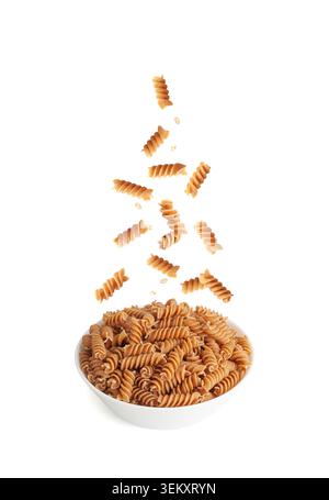 Falling Raw Brown Pasta Isolated, Wholegrain Fusilli Pile, Flying Dry Whole Grain Noodle, Raw Spelt Macaroni, Wholewheat Spiral Pasta on White Backgro Stock Photo