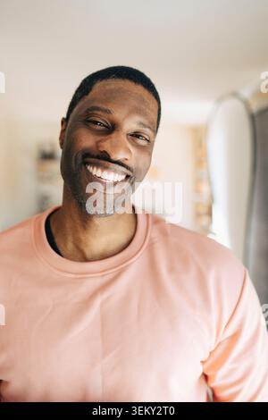 Portrait of happy mature man smiling at home Stock Photo