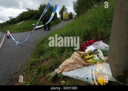 Flowers left near the scene in Sourton Down, near Okehampton in Devon, where a Royal Navy helicopter crashed in a field on Wednesday. Three members of the Royal Navy have died in the crash. Picture date: Thursday June 4, 2026. Stock Photo