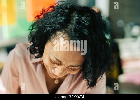 Close-up of happy businesswoman laughing at office Stock Photo
