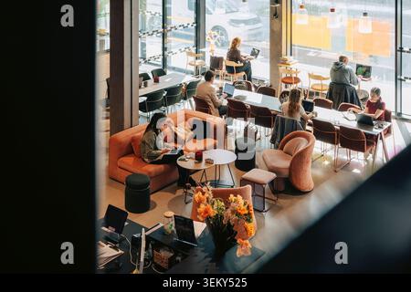 Group of business professionals working together in urban shared workspace Stock Photo