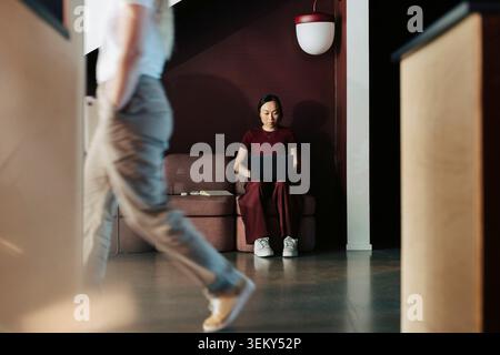 Female entrepreneur working on laptop while sitting and working at modern office Stock Photo