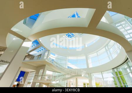 Los Angeles, California - January 8, 2026: Sunlight streams through the geometric skylights of the modern white rotunda entrance hall at the iconic Ge Stock Photo