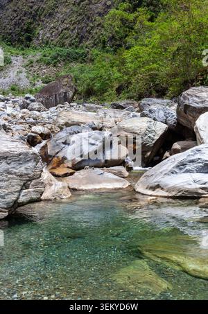 Large Rocks Uk Sanzhanxi river in Taroko National Park, Taiwan. Small waterfall flows ...