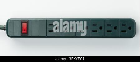 Power strip features several outlets and switch, ideal for connecting multiple devices at home or office settings. Stock Photo
