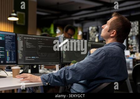 Startup admin thinking how to leverage machine learning tech in office to gain competitive edge. AI expert doing brainstorming to develop neural networks for rapid technological advancement Stock Photo