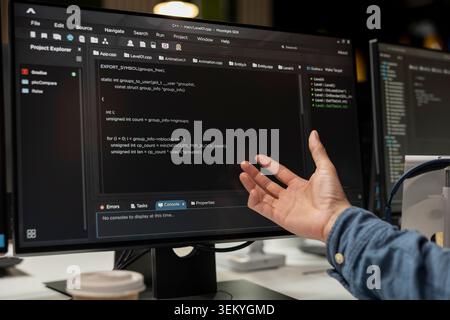 Close up of software developer coding on PC in startup office, refining machine learning models to enhance automation. IT expert using coding platform on computer in tech company workplace Stock Photo