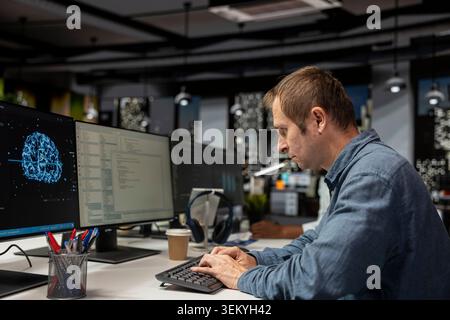 Computer scientist using machine learning in tech startup office to develop programs using AI automation. IT expert typing on PC keyboard, debugging applications with artificial intelligence Stock Photo
