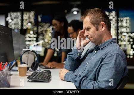 Admin feeling disappointed in startup office after noticing error in code written by colleagues while doing quality assurance. IT expert shaking head, disapproving mistakes in programming language Stock Photo