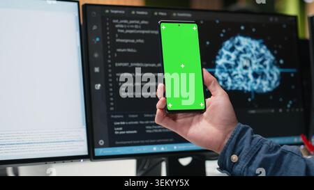 Isolated screen mobile phone used by admin in company workplace doing tech quality assurance. IT worker in office watches tutorial on programming languages with mockup smartphone, close up Stock Photo
