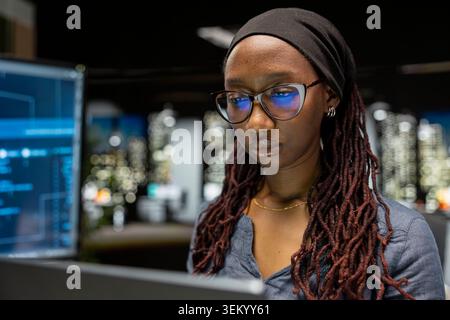 Close up of programmer typing on laptop keyboard in startup office, coding advanced machine learning models enhancing automation. African american woman uses AI on notebook in Silicon Valley workplace Stock Photo