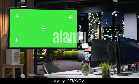 Isolated screen display in modern high rise office late at night used for developing artificial intelligence algorithms. Chroma key monitor in empty tech agency workplace building neural network Stock Photo