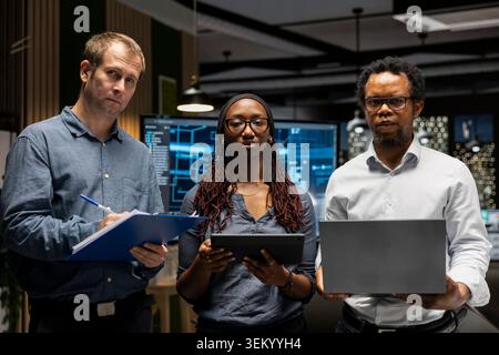 Portrait of teamworking engineers writing code, developing machine learning APIs. Team of IT professionals troubleshooting software errors using artificial intelligence, resolving system crashes Stock Photo