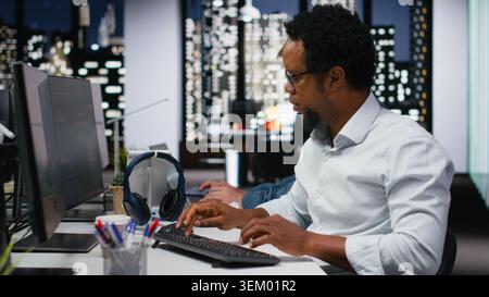 Software developer in company workplace doing artificial intelligence tech quality assurance. IT startup employee in office typing on keyboard, writing AI script with programming languages Stock Photo