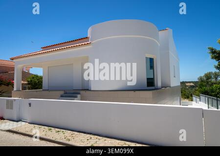 Monte Canelas Algarve Portugal, A contemporary residence featuring a striking curved facade and clean white walls Stock Photo