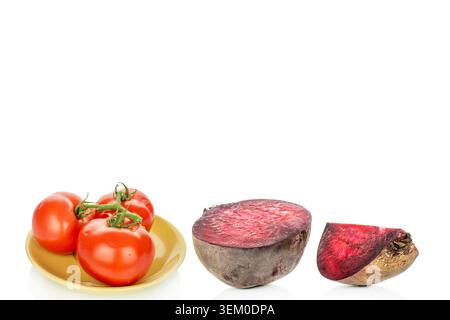 Red tomatoes with red beets, on a white background, close-up. Stock Photo